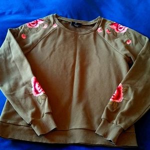 Olive green sweater with pink embroidery details